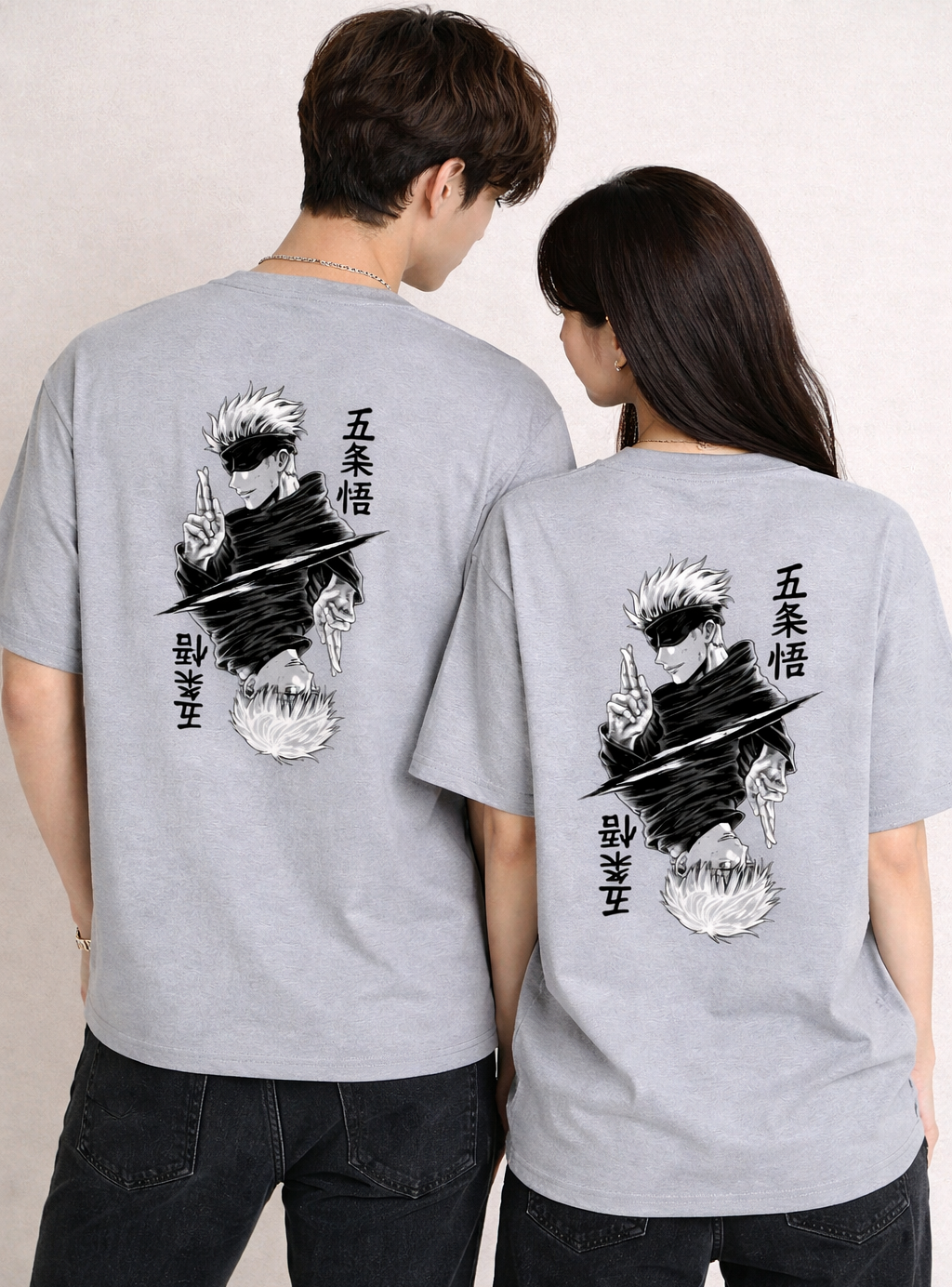 Two people wearing gray t-shirts with a graphic design on the back.