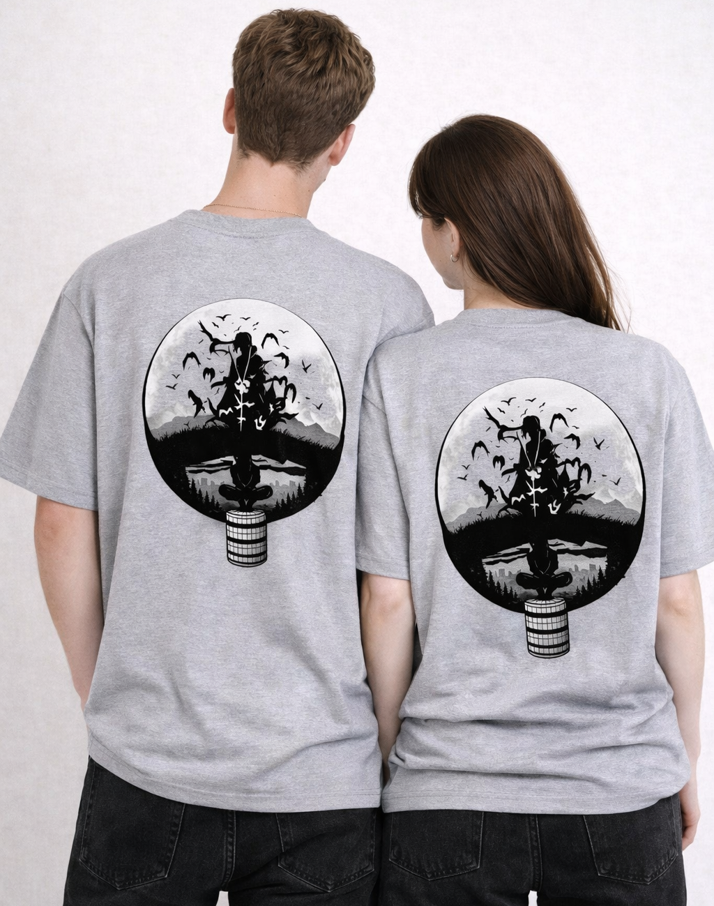 Two people wearing gray t-shirts with a black and white design on the back.