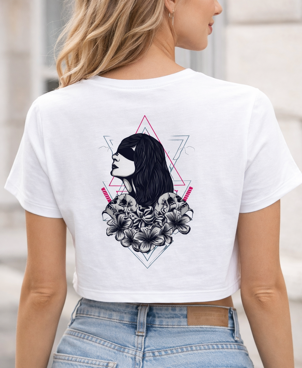 Person wearing a white t-shirt with a graphic design on the back.