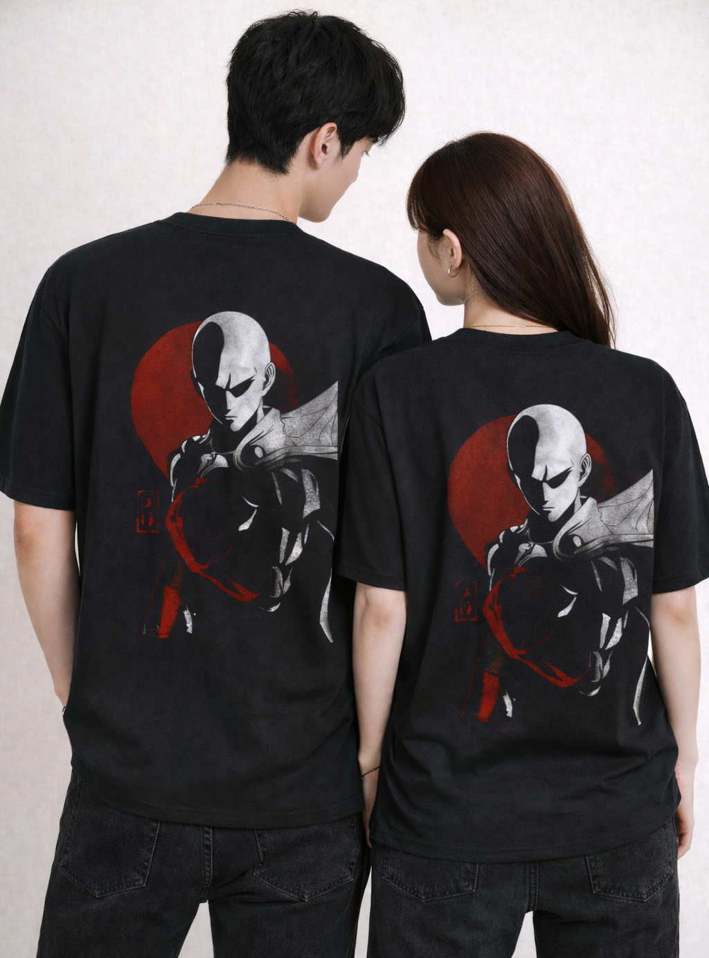 Two people wearing black t-shirts with a graphic design on the back.