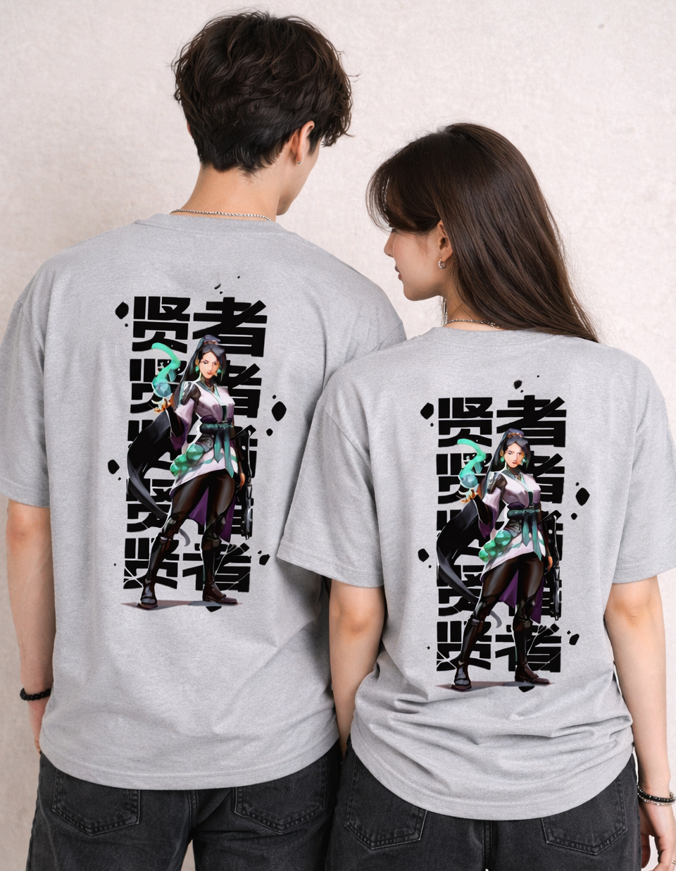 Two people wearing gray t-shirts with a graphic design on the back against a plain background